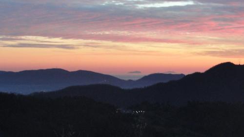 a view of a mountain range with a sunset at Collina Di Sopra in Tresana