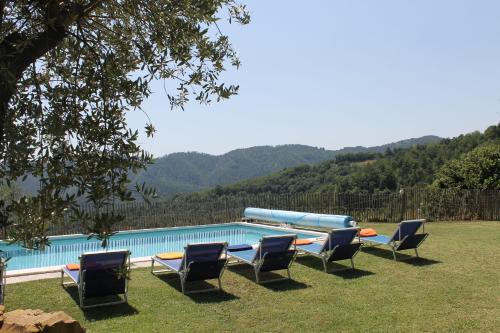 a group of chairs and a swimming pool at Collina Di Sopra in Tresana
