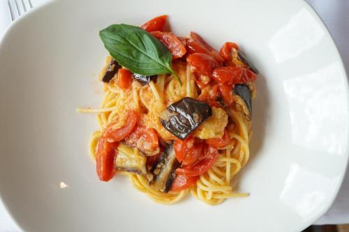 a white plate of pasta with seafood and vegetables at Locanda 19 al paradiso in Mirano