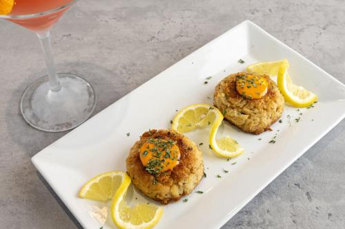 a white plate with two scones with lemon slices at Hotel Indigo Orange Beach - Gulf Shores by IHG in Gulf Shores