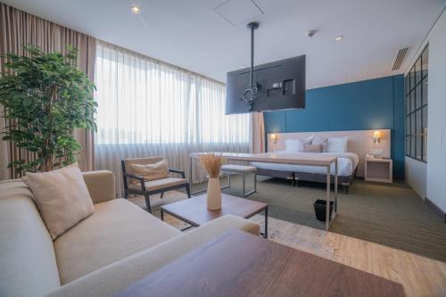 a hotel room with a bed and a couch at SHG Liv Zona G Hotel in Bogotá