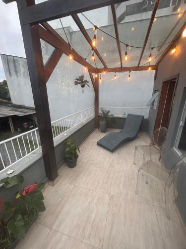 a balcony with lights and plants on a building at RCM Vilas - Casa Descolada in Joinville