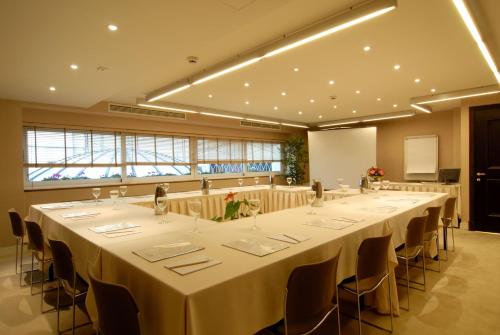 a conference room with a long table with chairs at Hera Hotel in Athens