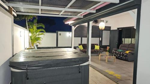 a living room with a couch and a table at Les cocotiers d'Aladya in Lamentin