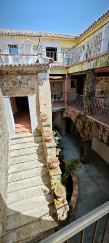 an old building with stairs and a bridge at Palazzo Cafarelli in Laureana Cilento