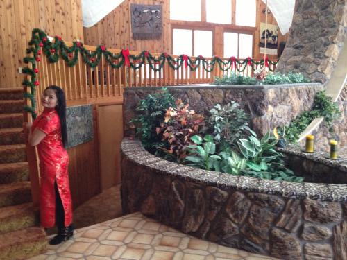 a woman standing next to a large rock garden at HOUSE OF THE FUTURE MANSION MASTER BEDROOM, In W LANSING in Lansing