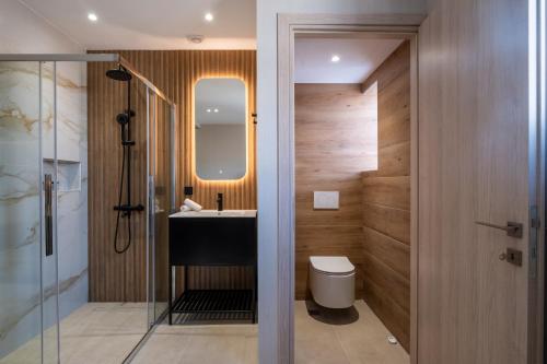 a bathroom with a sink and a toilet and a mirror at Agora Views in Athens