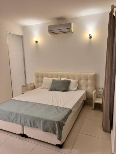 a bedroom with a bed and a air conditioner on the wall at Umayra Boutique Hotel in Bodrum City