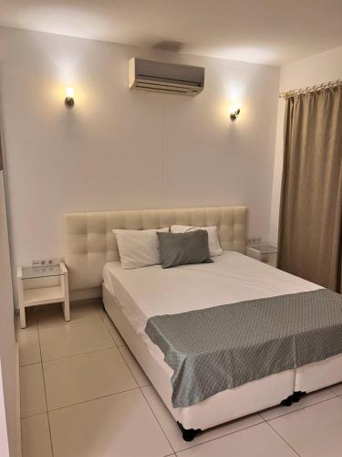 a bedroom with a bed and a air conditioner at Umayra Boutique Hotel in Bodrum City