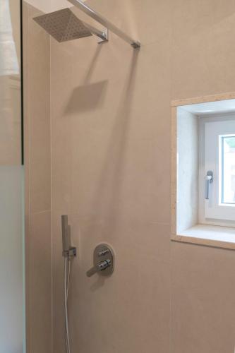 a shower with a shower head and a window at Stabiae Suite&Spa Sorrento Coast Suites in Castellammare di Stabia