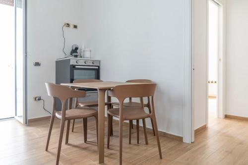 a kitchen with a wooden table and chairs at Stabiae Suite&Spa Sorrento Coast Suites in Castellammare di Stabia