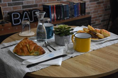 a table with a plate of bread and french fries at Il Vecchio Casale B&B in Sedini
