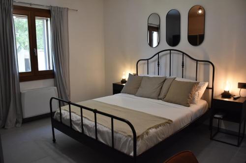 a bedroom with a bed and mirrors on the wall at Il Vecchio Casale B&B in Sedini