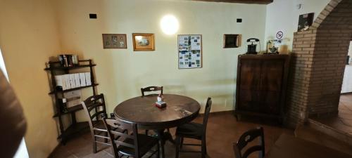 a dining room with a wooden table and chairs at Palazzo Cafarelli in Laureana Cilento