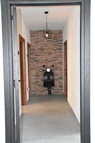 a motorcycle parked in a hallway with a brick wall at Il Vecchio Casale B&B in Sedini