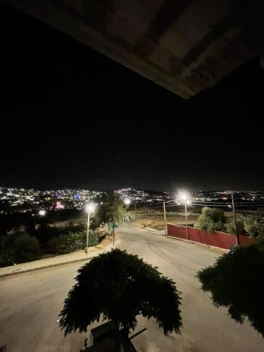 an empty street at night with street lights at Sky 2 in Jerash