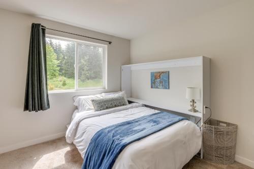 a white bedroom with a bed and a window at 2 Mi to Olympic National Park Hot Tub Haven! in Port Angeles