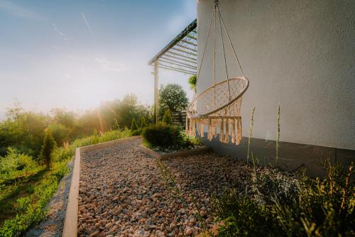 a swing on the side of a building at Panorama Villa House Sarajevo- Jacuzzi, Bazen & Pogled na Grad 2 in Petruše