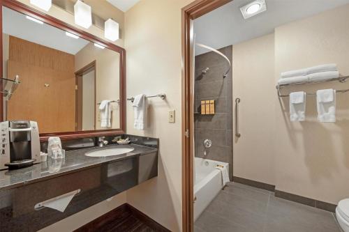 a bathroom with a sink and a shower at Best Western Plus City Center in Spokane