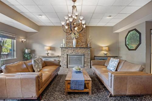 a living room with leather couches and a fireplace at Best Western Plus City Center in Spokane