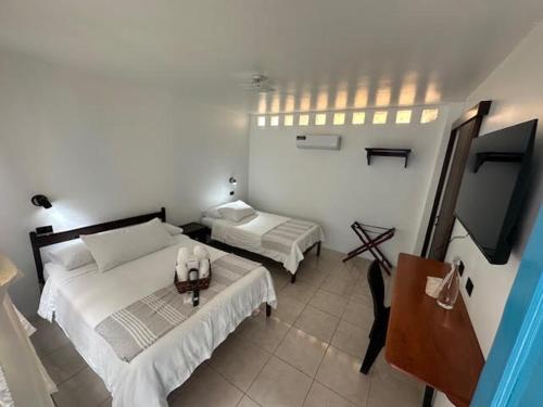 a bedroom with a bed and a tv in it at Cactus in Puerto Baquerizo Moreno