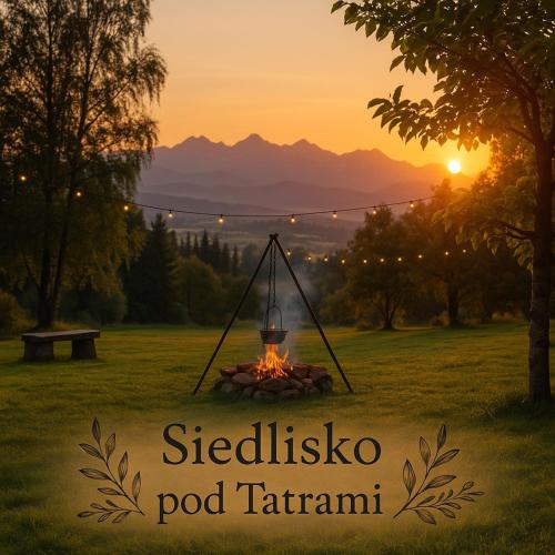 a fire pit in a field with the sunset in the background at Siedlisko pod Tatrami - agroturystyka in Maruszyna