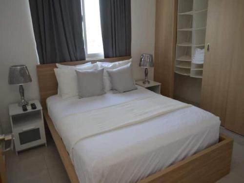 a bedroom with a large bed with white sheets and pillows at Relaxing Ocean View Getaway in Boca Chica in Boca Chica
