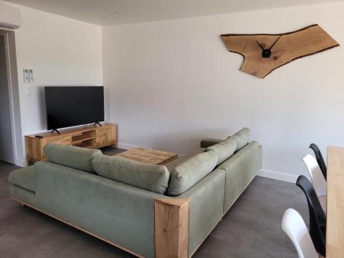 a living room with a couch and a flat screen tv at Les écuries in Secondigny