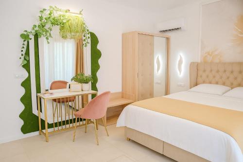 a bedroom with a bed and a desk with a chair at Vila AMAZON in Dubova