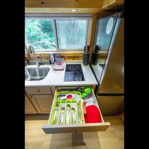 a kitchen with a sink and a counter top at Serene Blue Ridge Mountain Stay in Luxe Tiny Home in Nellysford