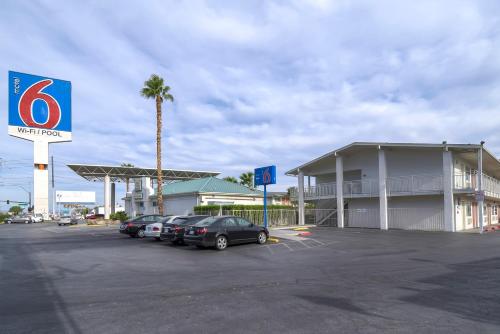 a parking lot with cars parked in front of a hotel at Tropicana Stays By Townhouse in Las Vegas