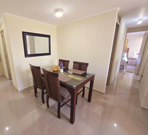 a dining room with a wooden table and chairs at Apartamento Premium frente a Universidad San Marcos para 4 pers en lima in Lima
