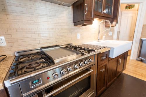 a kitchen with a stove and a sink at Les 4 Saisons - No breakfast in Quebec City