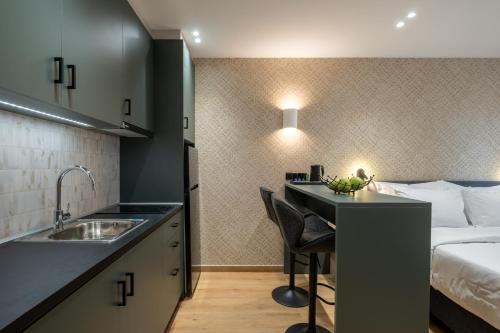 a kitchen with a sink and a bed in a room at Agora Views in Athens