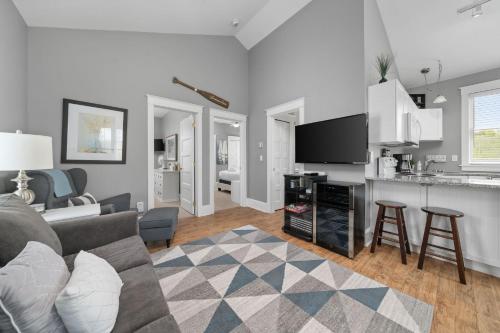 a living room with a couch and a kitchen at The Rushes - 47 Butternut in Cherry Valley