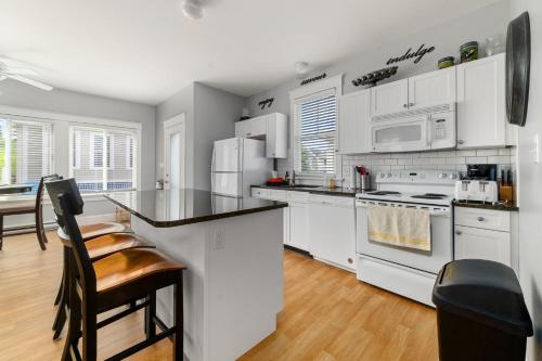 a kitchen with white appliances and a counter top at The Cattail - 26 Meadowview in Cherry Valley