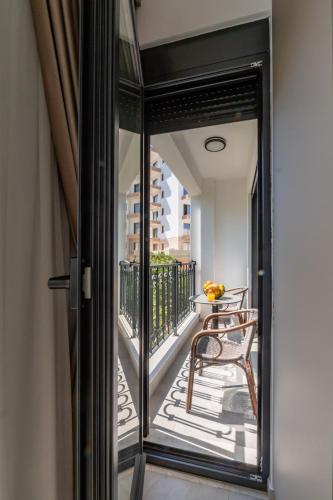 a glass door leading to a balcony with a table at Wave Apartments - Dobra Voda in Bar