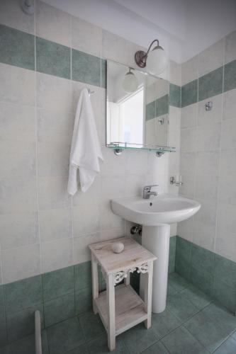 a bathroom with a sink and a mirror at Astarti Apartments in Livadi