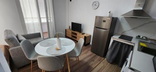 a small living room with a table and a refrigerator at Old Town City Center 2 in Durrës