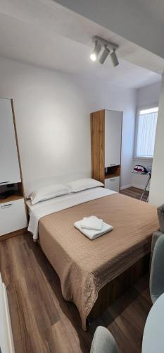 a bedroom with a bed with a towel on it at Old Town City Center 2 in Durrës