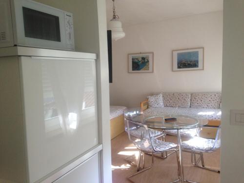 a living room with a table and a couch at Residence Geranio in Domaso