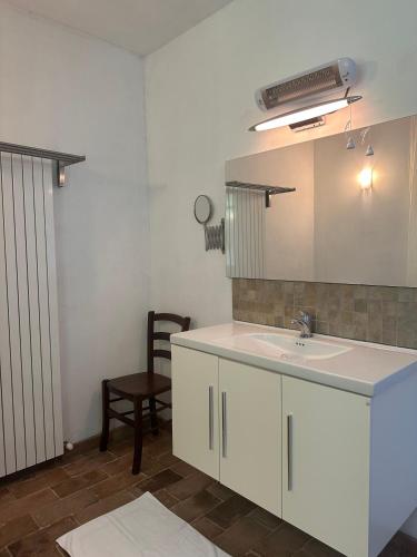 a bathroom with a sink and a mirror at Collina Di Sopra in Tresana