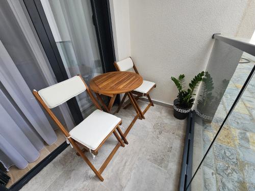 two chairs and a table on a balcony at Apartments Ivo Herceg Novi in Herceg-Novi
