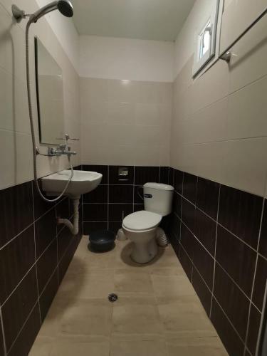 a bathroom with a toilet and a sink at ELIT Holiday Village in Obzor