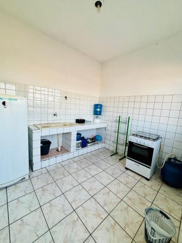 a kitchen that is being remodeled with a stove and refrigerator at Apartamento mobiliado em Contagem - 2 quartos in Contagem