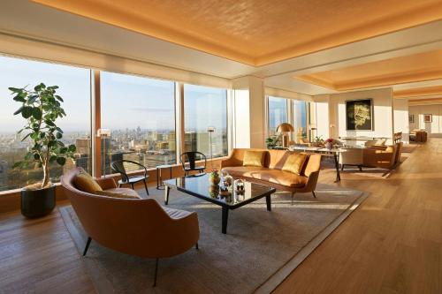 a living room with a couch and chairs and a table at Bvlgari Hotel Tokyo in Tokyo