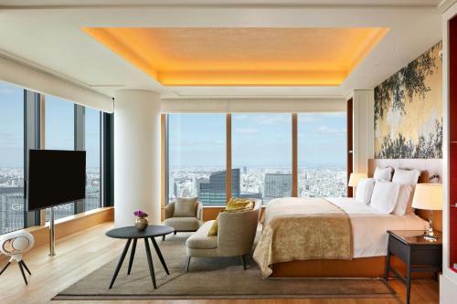 a bedroom with a large bed and a large window at Bvlgari Hotel Tokyo in Tokyo