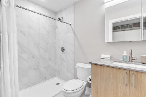 a bathroom with a shower and a toilet and a sink at Waterfront Studio - Steps from Fishtown and Old City in Philadelphia