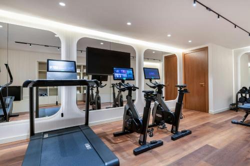 a gym with treadmills ellipticals and exercise bikes at Grand Hotel Centenari, Valencia, Autograph Collection in Valencia