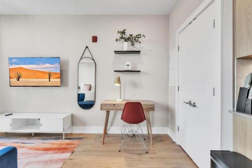a room with a desk and a mirror and a red chair at Waterfront Studio - Steps from Fishtown and Old City in Philadelphia